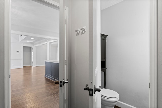 bathroom featuring hardwood / wood-style flooring and toilet