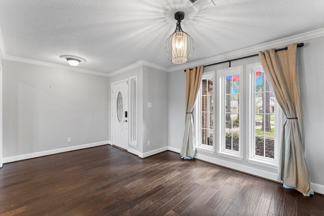 foyer entrance with crown molding, dark hardwood / wood-style flooring, a chandelier, and a textured ceiling