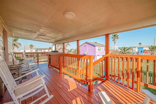 wooden terrace featuring a shed