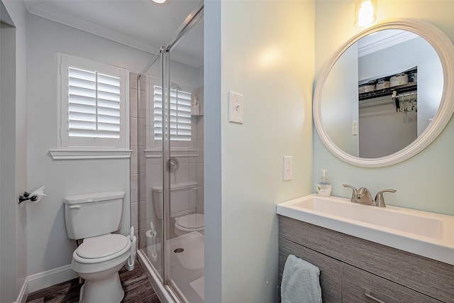 bathroom featuring crown molding, toilet, and an enclosed shower