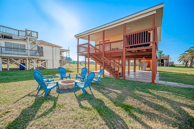 view of yard featuring a deck, a patio, and a fire pit