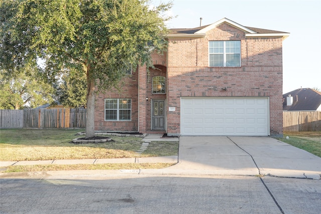 front of property featuring a front yard and a garage