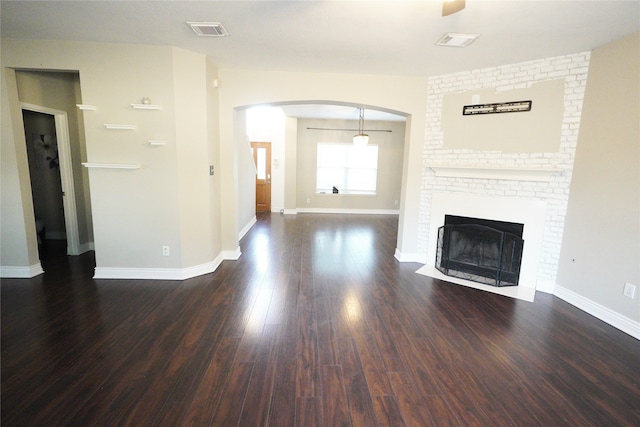 unfurnished living room featuring dark hardwood / wood-style flooring and a fireplace