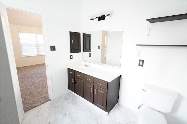 bathroom featuring vanity, toilet, and electric panel