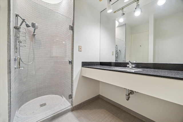 bathroom featuring tile patterned floors, a shower with door, and vanity