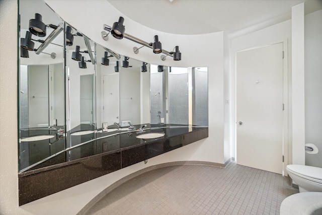 bathroom with tile patterned flooring, toilet, and sink