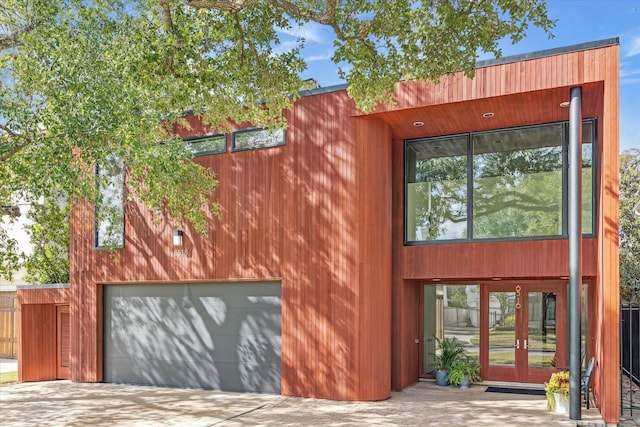 exterior space with a garage and french doors