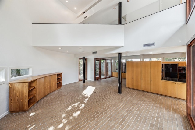 interior space with a healthy amount of sunlight and a towering ceiling