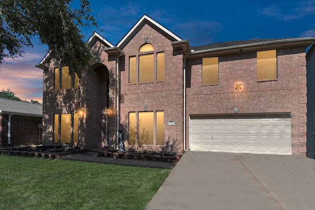 view of front facade featuring a garage and a lawn