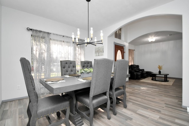 dining area with an inviting chandelier and hardwood / wood-style flooring