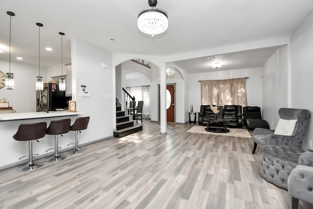 living room with light hardwood / wood-style flooring and sink