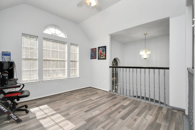 home office featuring lofted ceiling, hardwood / wood-style floors, and plenty of natural light