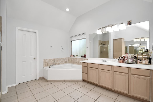 bathroom with vanity, tile patterned floors, vaulted ceiling, and shower with separate bathtub