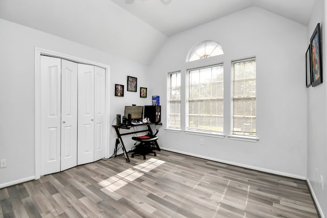 office area featuring light wood-type flooring and vaulted ceiling