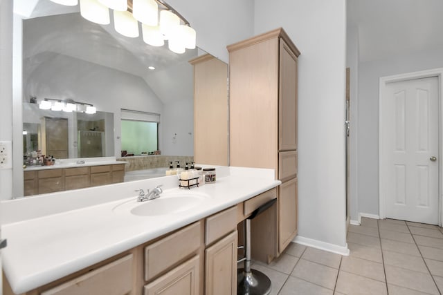 bathroom with vanity, lofted ceiling, and tile patterned floors