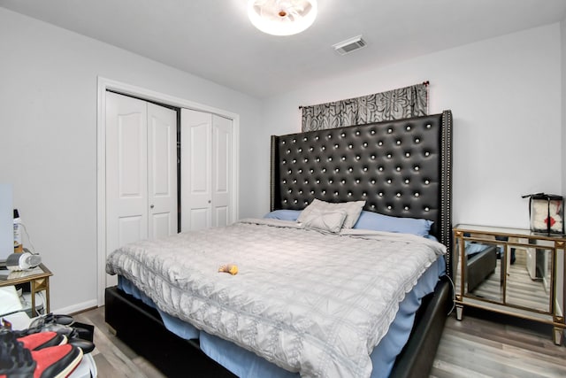 bedroom featuring hardwood / wood-style floors and a closet