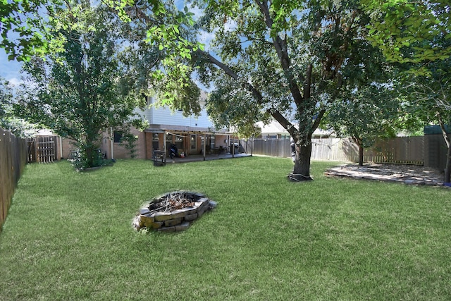 view of yard featuring an outdoor fire pit and a patio