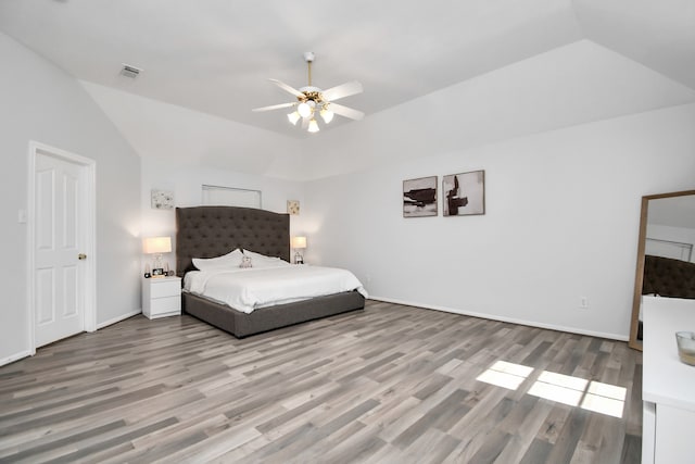 unfurnished bedroom featuring ceiling fan, hardwood / wood-style flooring, and lofted ceiling