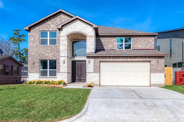 view of front of property featuring a garage and a front lawn