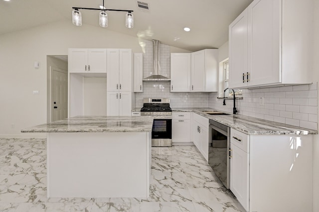 kitchen featuring wall chimney exhaust hood, a kitchen island, and white cabinetry