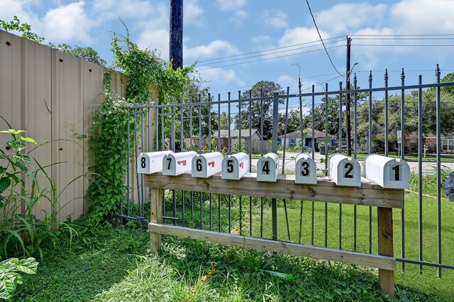 view of gate featuring a yard