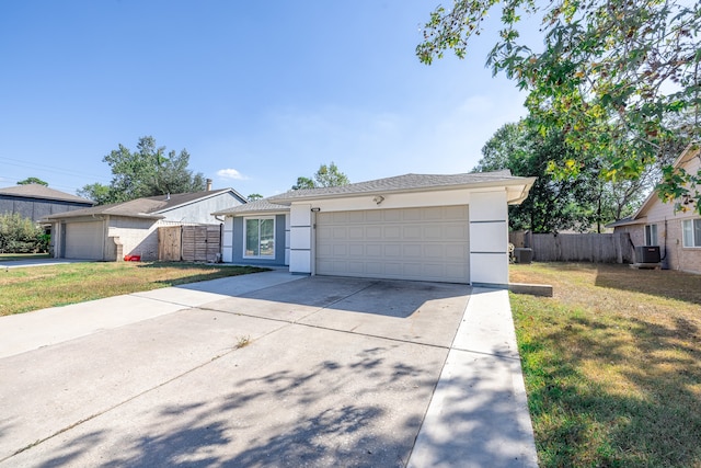 single story home featuring central air condition unit, a front lawn, and a garage