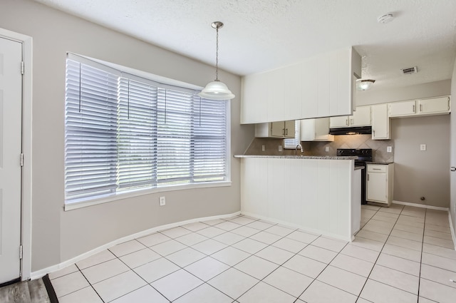 kitchen featuring decorative backsplash, kitchen peninsula, white cabinets, and decorative light fixtures