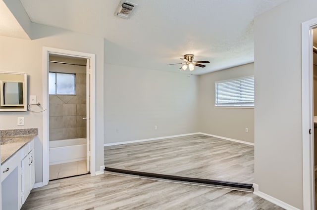 bathroom with vanity, hardwood / wood-style flooring, and plenty of natural light