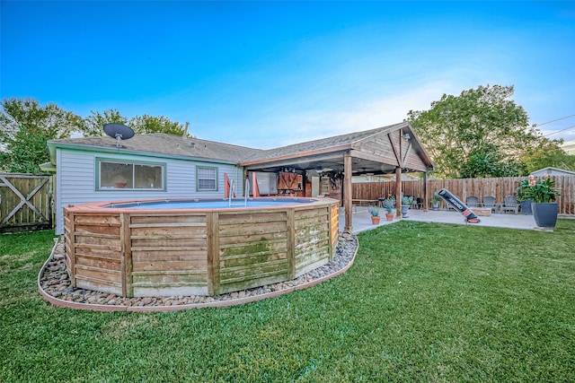 back of house featuring a patio area and a lawn