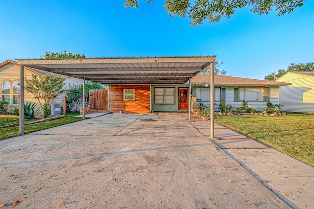 ranch-style home with a carport and a front lawn