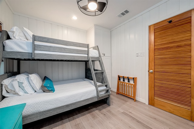 bedroom featuring light hardwood / wood-style floors and crown molding