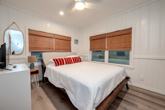 bedroom with ceiling fan and hardwood / wood-style floors