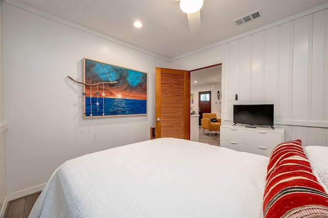 bedroom featuring crown molding, hardwood / wood-style flooring, and ceiling fan