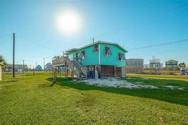 back of house with a lawn