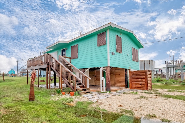 back of house with a yard and a deck