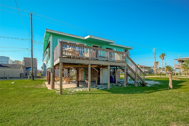 back of house with a yard, a patio, and a deck