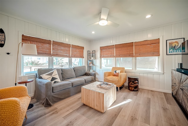 living room featuring light wood-type flooring and ceiling fan