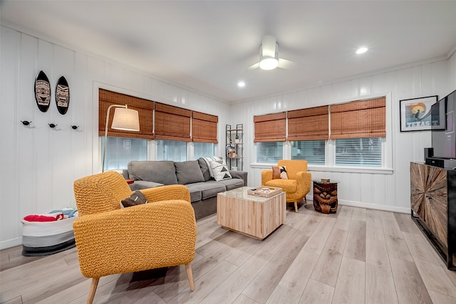 living room with light wood-type flooring and ceiling fan