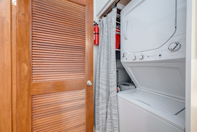 washroom with stacked washer and dryer