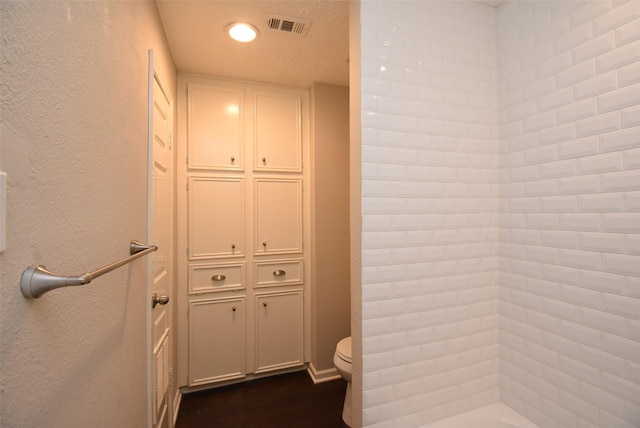 bathroom with a shower and toilet