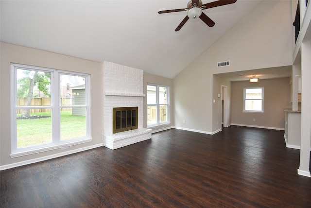 unfurnished living room with a fireplace, a wealth of natural light, high vaulted ceiling, and ceiling fan