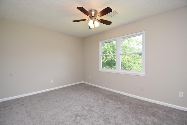 empty room featuring carpet flooring and ceiling fan