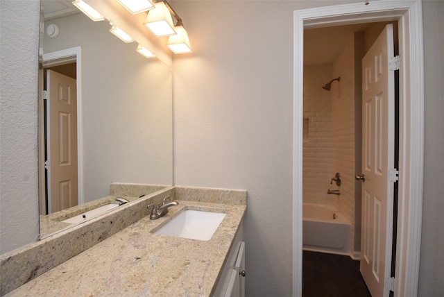 bathroom with vanity and tiled shower / bath