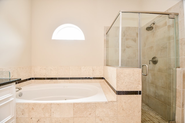 bathroom with vanity and plus walk in shower