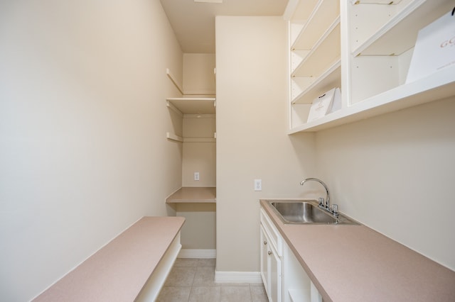 kitchen featuring sink and light tile patterned floors