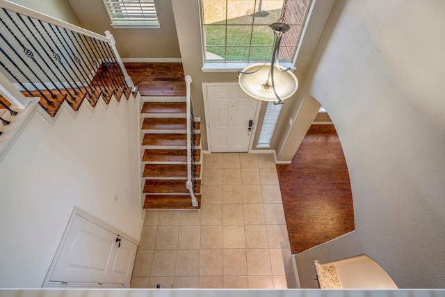 tiled entryway featuring a high ceiling