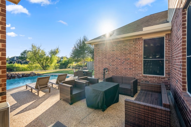 view of patio with an outdoor living space and pool water feature