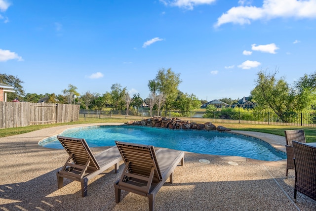 view of pool featuring a yard