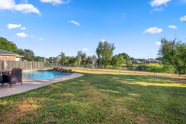 view of pool featuring a yard, a patio, and pool water feature