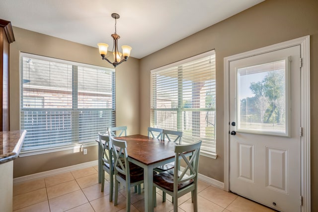 tiled dining space with a notable chandelier and a wealth of natural light